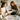 Two women opening a gift box with 'Dulenn' branding in a cozy indoor setting.